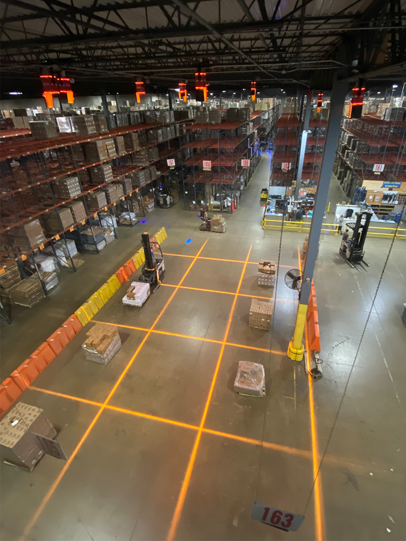 Amber safety lines projected onto the floor