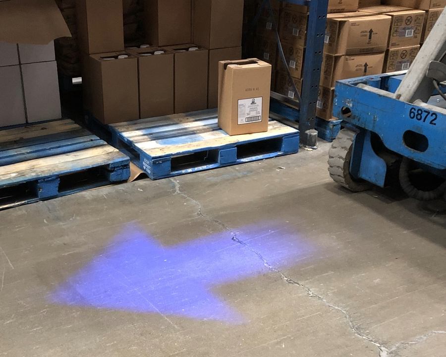Blue arrow projected onto the floor