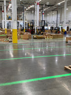 Green VirtuaLine Projected Lines reflecting on the floor to indicate pallet staging areas
